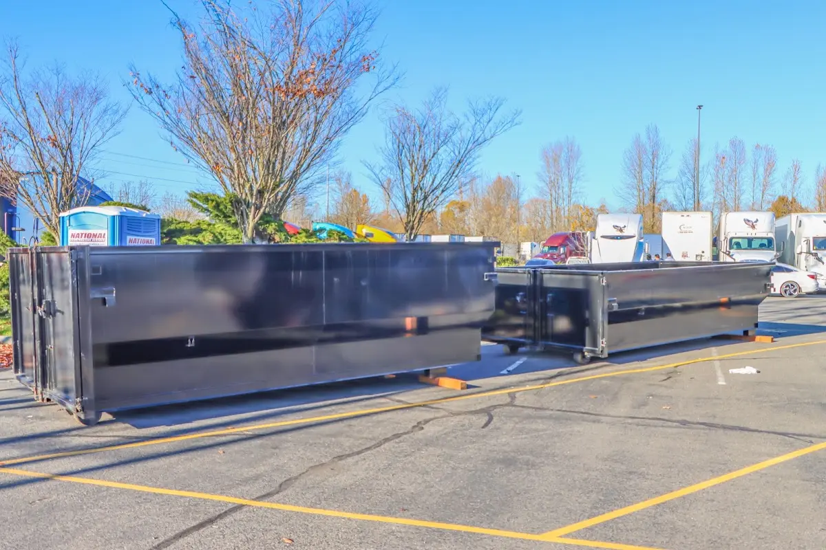 Professional dumpster rental service with roll-off container on residential driveway in Marlene Village